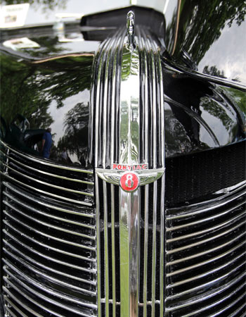 Decorative image - close up of classic Pontiac V8 front grill chrome on high gloss black